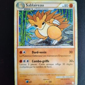 Sablaireau 29/123. Carte du TCG Pokémon issue de la série HeartGold SoulSiver du bloc HeartGold SoulSilver, parue le 05/05/2010. Carte Pokémon Niveau 1 de type Combat, évolution de Sabelette. Rare. Illustrateur: Yukiko Baba. L'image représente un dessin d'un blaireau orange dans une forêt de bambous.