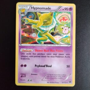 Hypnomade 51/122. Carte du TCG Pokémon issue de la série Rupture Turbo du bloc XY (XY09, XY: Rupture Turbo), parue le 06/02/2016. Carte Pokémon Niveau 1 de type Psy, évolution de Soporifik, Rare. Illustrateur: Tomokazu Komiya. L'illustration représente un tapir à collerette blanche dans un paysage déstructuré séparé en 2 parties oniriques.