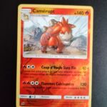 Camérupt (reverse) 14/111. Carte du TCG Pokémon issue de la série Invasion Carmin du bloc Soleil et Lune (SL04, SL: Invasion Carmin), parue le 04/11/2017. Carte Pokémon de Niveau 1 de type Feu, évolution de Chamallot. Rare. Illustrateur: Anesaki Dynamic. L'illustration représente une créature orange semblable à un chameau vu de face, dans un paysage montagneux.