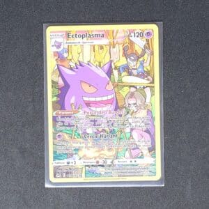 Ectoplasma TG06 Pokémon Origine Perdue. Carte du TCG Pokémon issue du bloc Epée et Bouclier parue le 25 août 2021 et du set Origine Perdue. Carte Pokémon de type Psy. TG06. Illustrateur: Akira Komayama. L'illustration représente le Pokémon Ectoplama Gengar qui sourit à côté d'un feu de camp.
